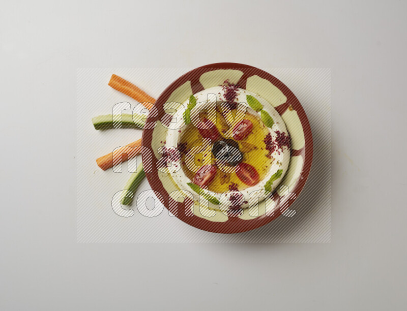 Lebnah garnished with Cherry tomato, mint & sumak  in a traditional plate on a white background