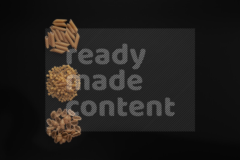 Different pasta types in 3 bunches on black background