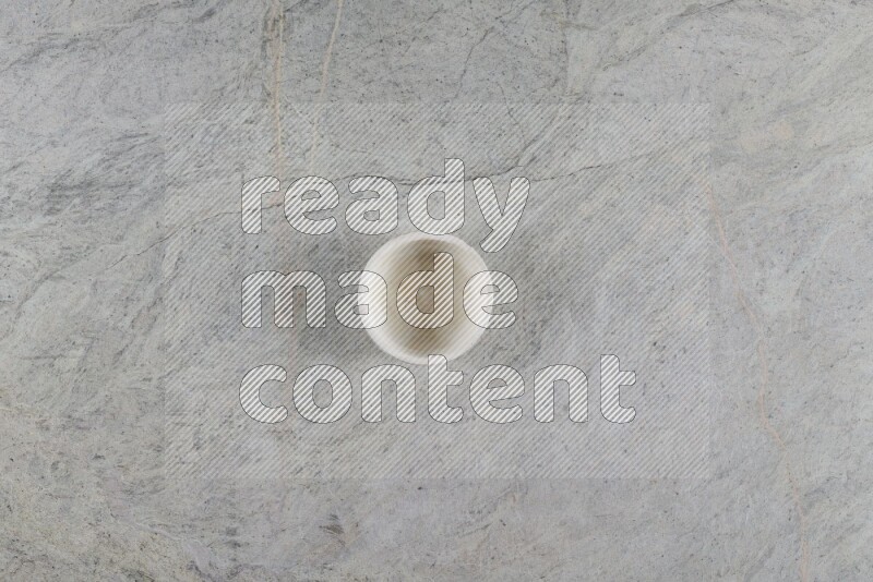A multicolored pottery Cup on grey marble background
