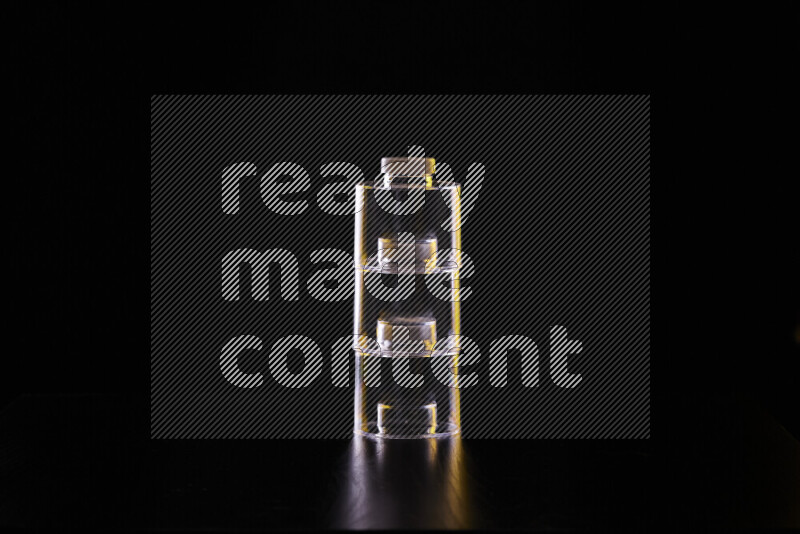 Glassware with rim light in yellow and white against black background