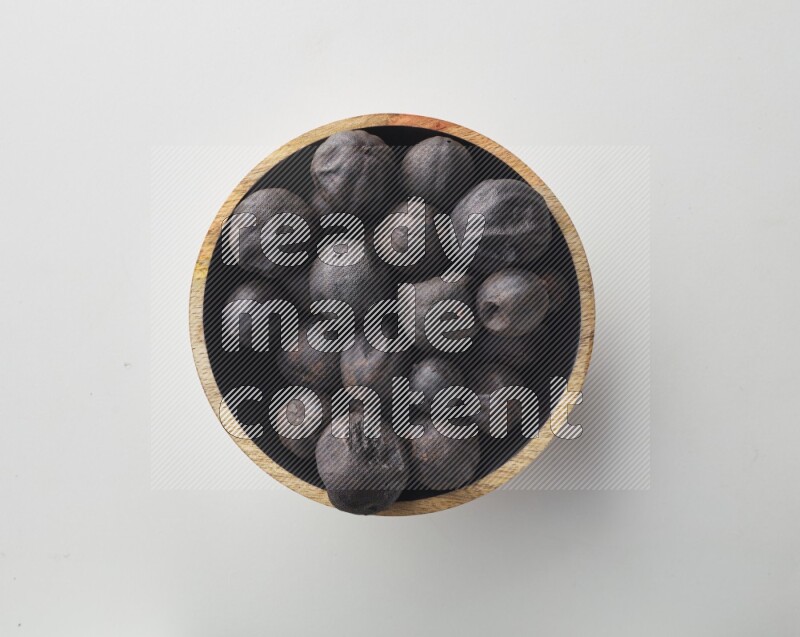 Top-view shot of dried lime (loomi) in a container on white background