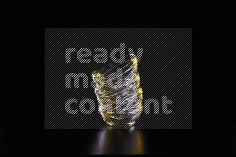 Glassware with rim light in yellow and white against black background