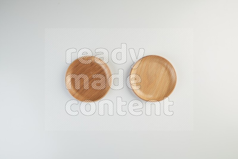Wooden bowl and plate on white background