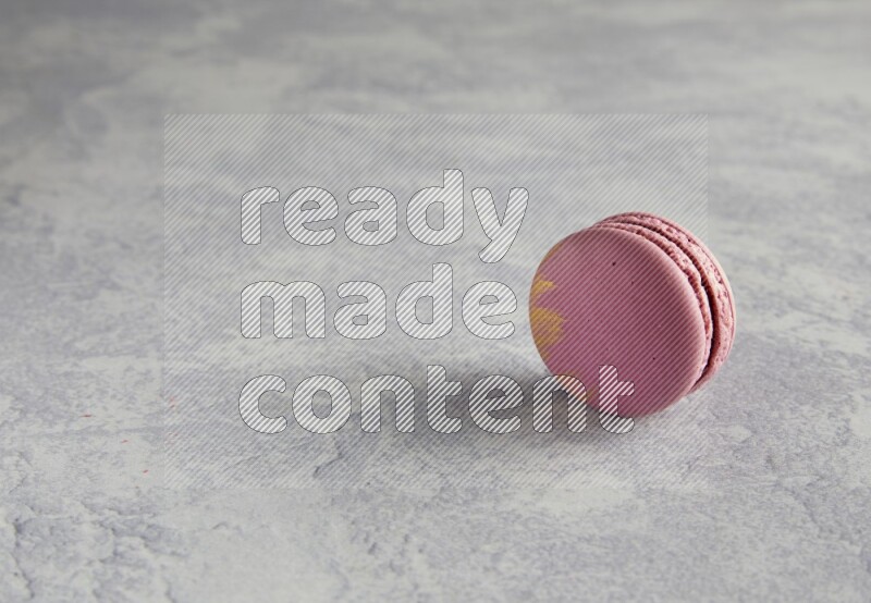 45º Shot of Purple Strawberry macaron on white  marble background