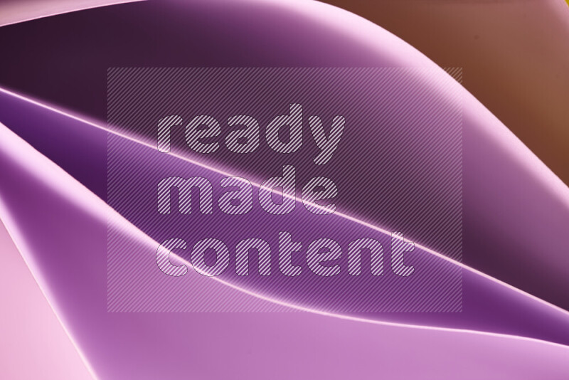 This image showcases an abstract paper art composition with paper curves in purple and gold gradients created by colored light