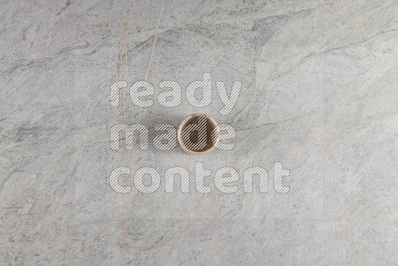 Top View Shot Of A Multicolored Pottery Cup On Grey Marble Flooring