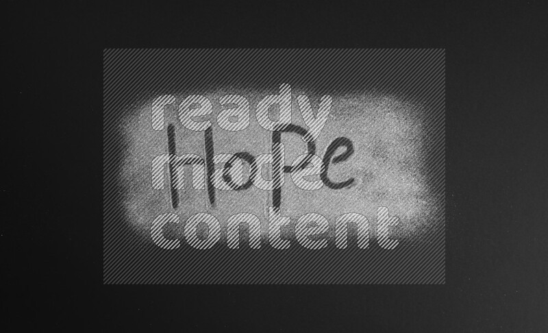 A word written with silver glitter on black background