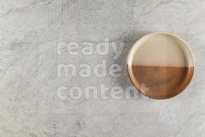 Top View Shot Of A Multicolored Pottery Oven Plate On Grey Marble Flooring