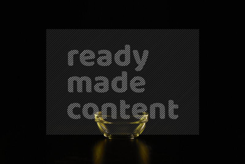 Glassware with rim light in yellow against black background