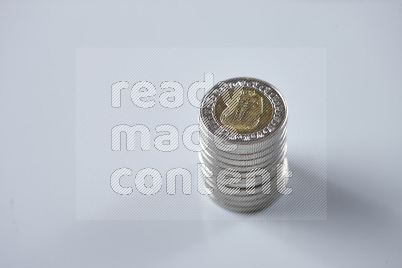 Stack Egyptian one pound coins on grey background