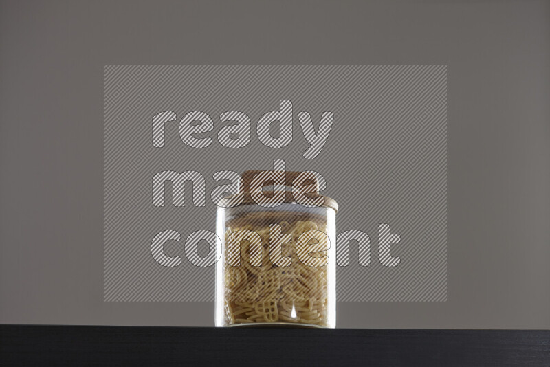 Snacks in a glass jar on black background