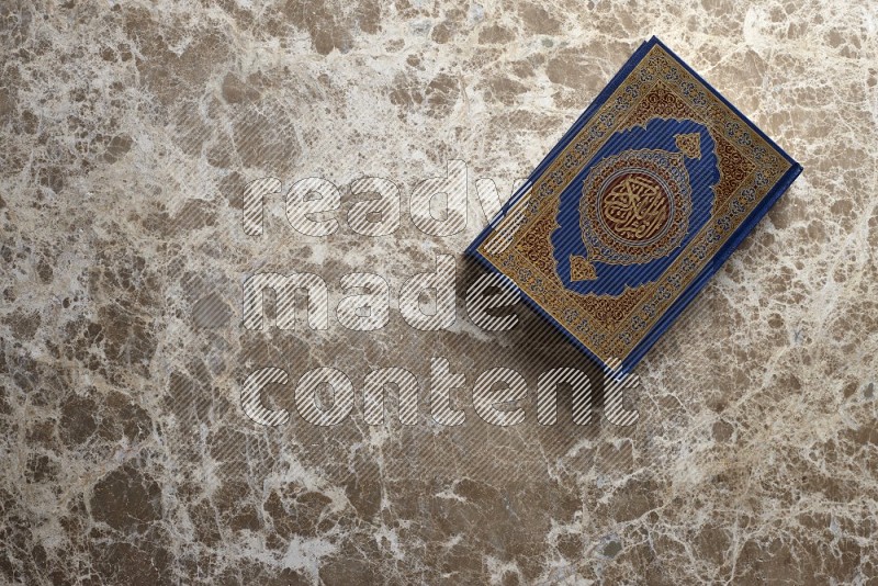 Quran on beige marble background