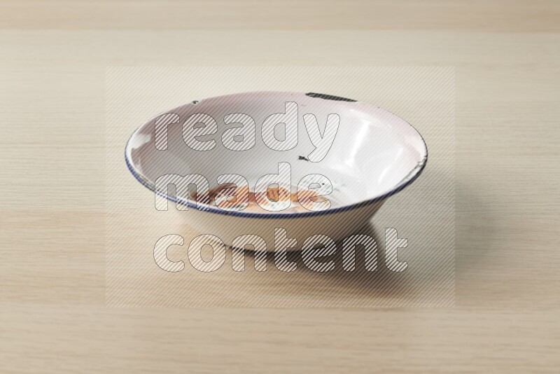 A vintage metal plate on light wooden background