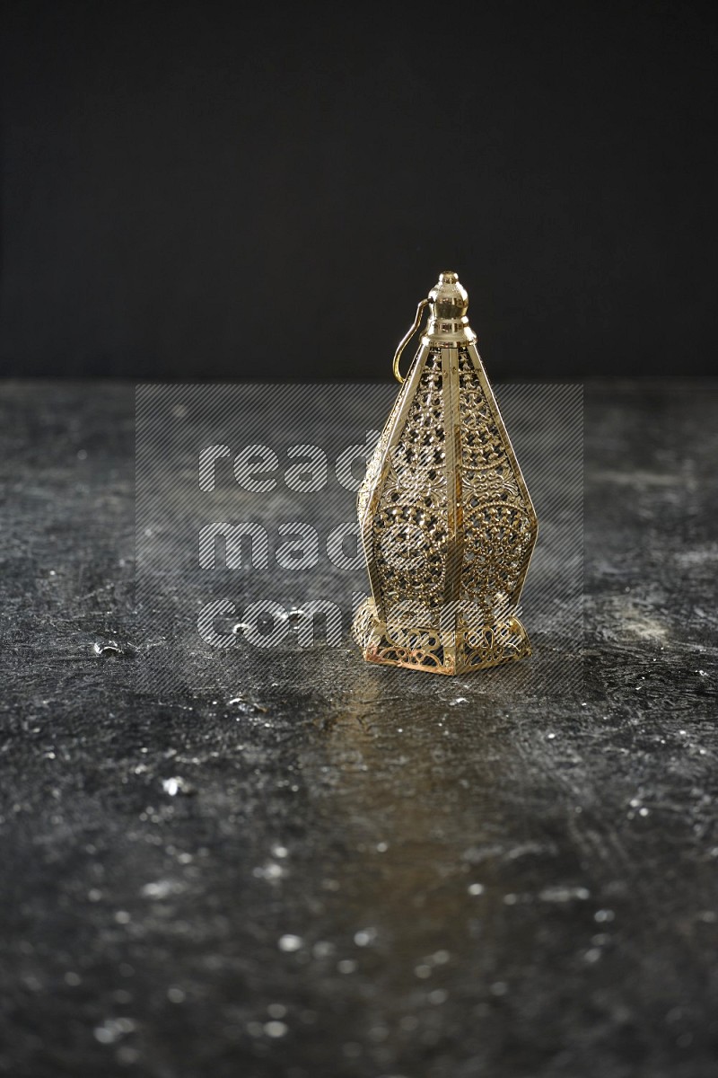 A lantern placed on a textured black background