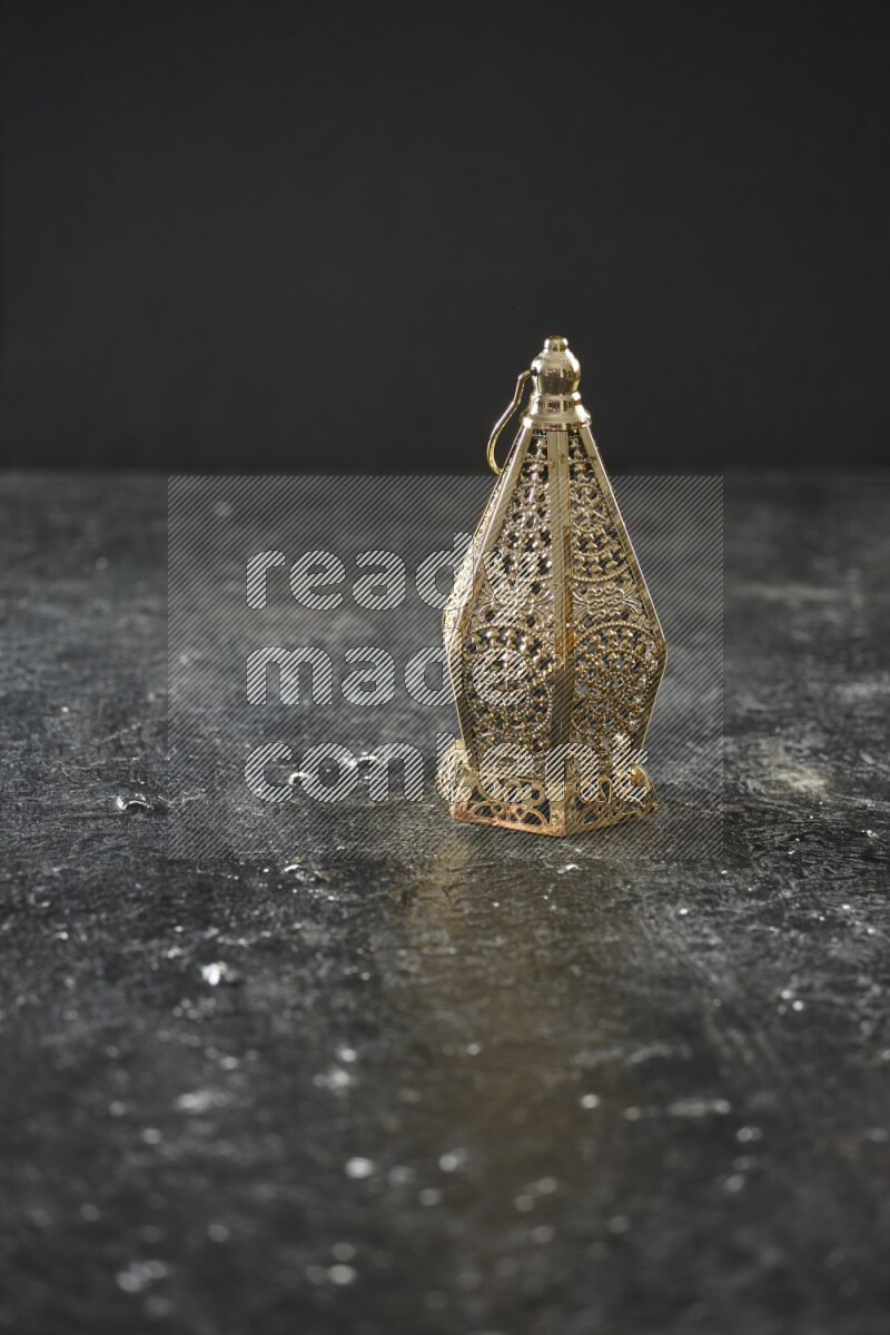 A lantern placed on a textured black background