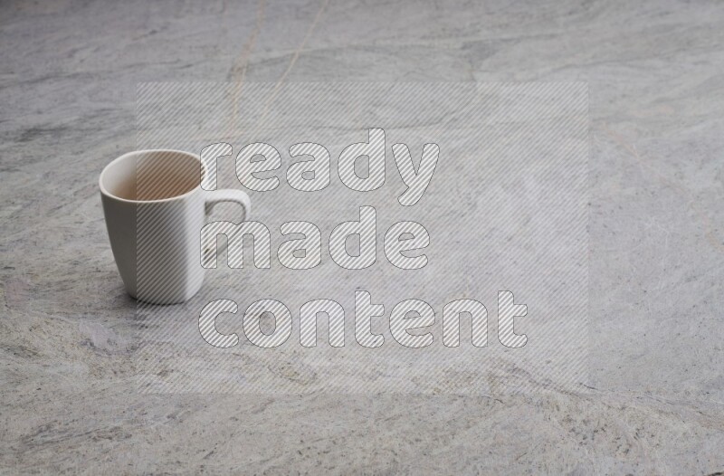 A white ceramic mug on grey marble background