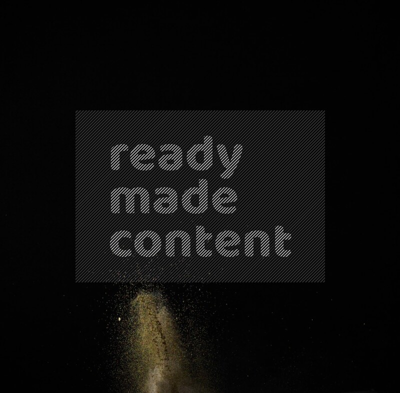 A side view of brown powder explosion on black background