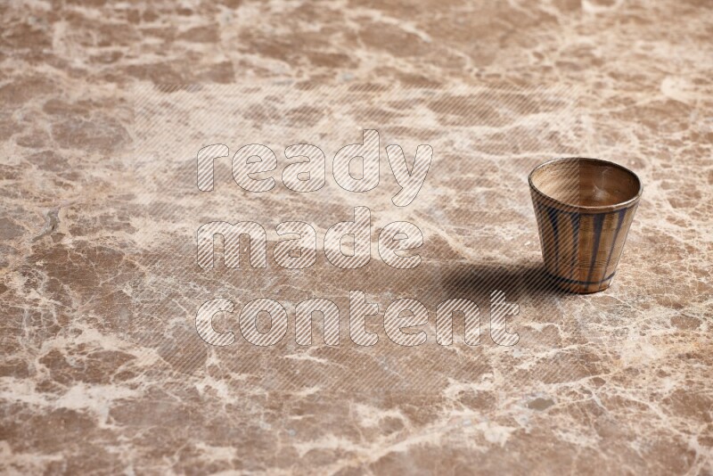 Pottery Cup on Beige Marble Flooring