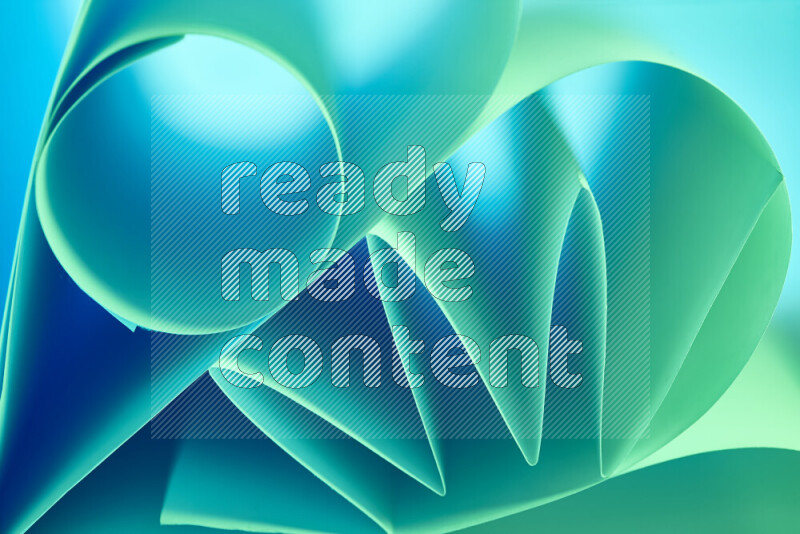 An artistic display of paper folds creating a harmonious blend of geometric shapes, highlighted by soft lighting in green and blue tones