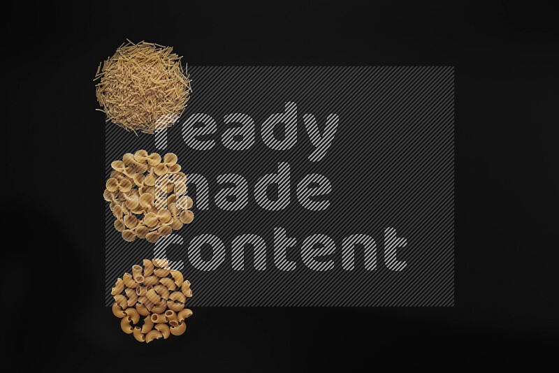 Different pasta types in 3 bunches on black background