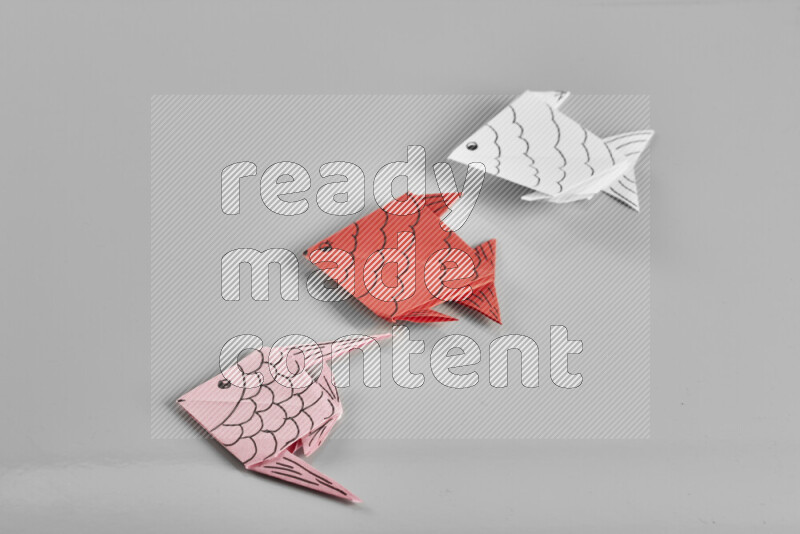 Origami fish on grey background
