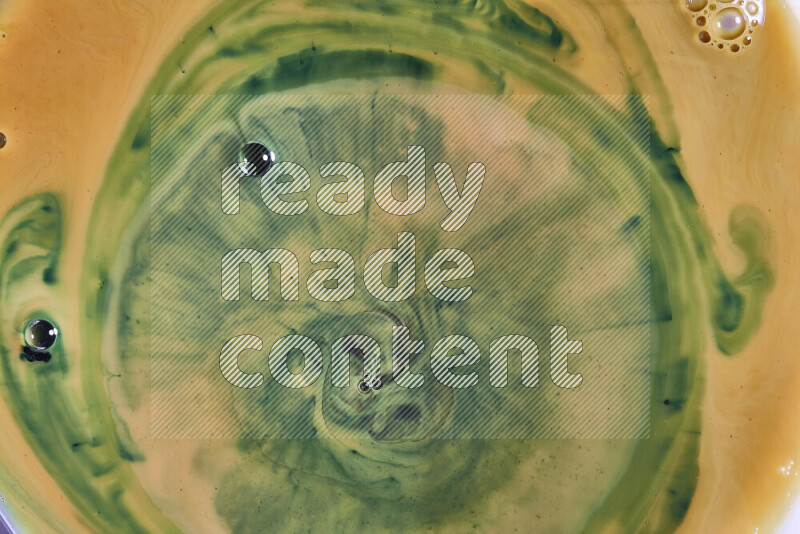 لقطة مقربة لأنماط دوامية باللون البرتقالي والأخضر