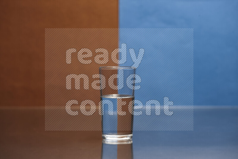 The image features a clear glassware filled with water, set against brown and blue background