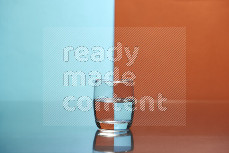 The image features a clear glassware filled with water, set against light blue and dark orange background