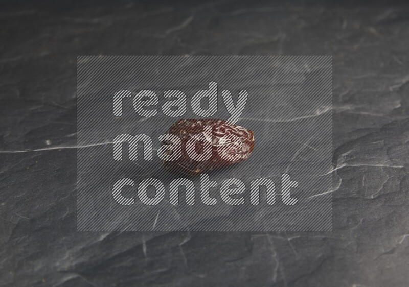 one madjoul date on a black textured background