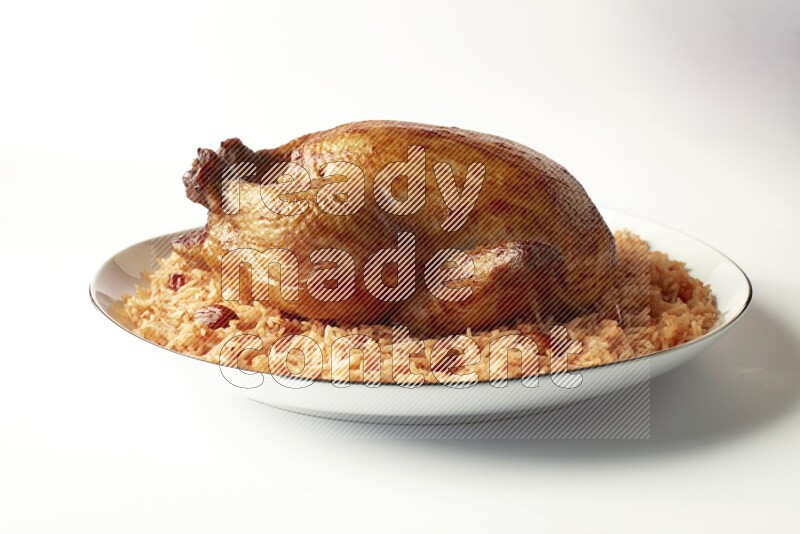red basmati Rice with whole roasted chicken on a white plate with a silver rim direct on white background