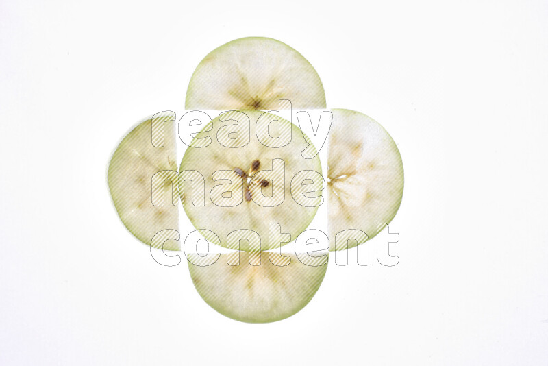 Apple slices on illuminated white background