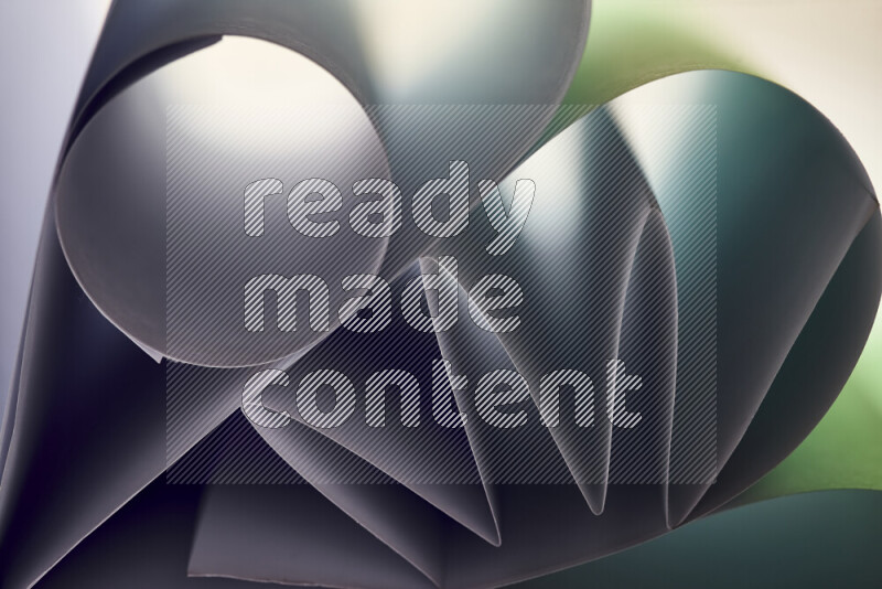 An artistic display of paper folds creating a harmonious blend of geometric shapes, highlighted by soft lighting in green tones