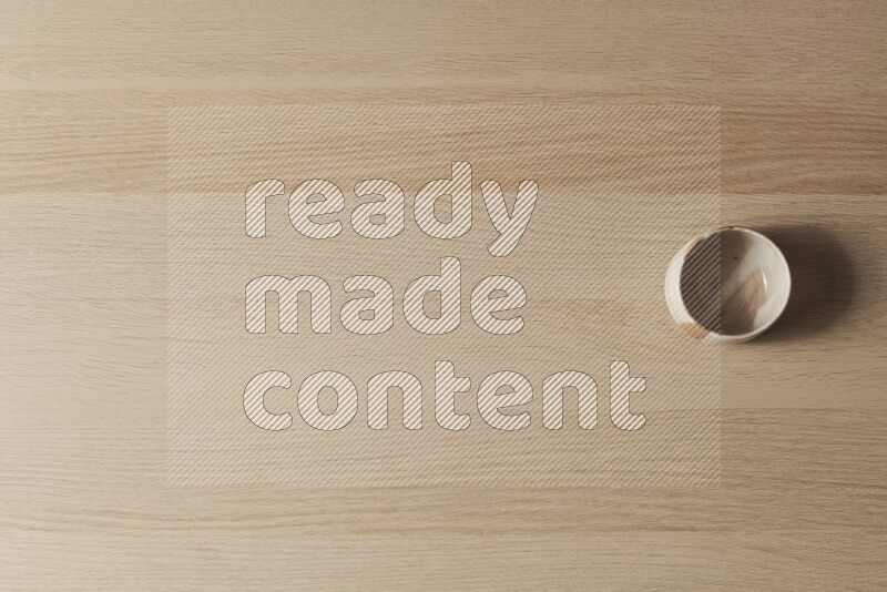 A multicolored pottery bowl on light wooden background