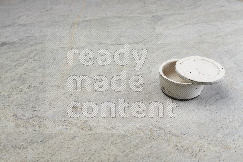 White Pottery Bowl On Grey Marble Flooring