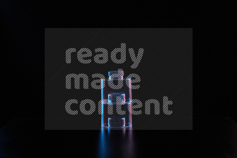 Glassware with rim light in red and blue against black background