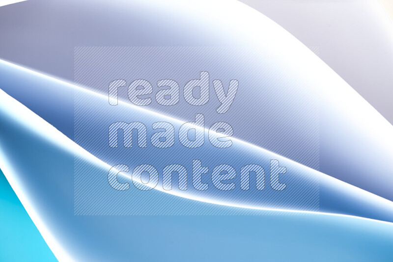 This image showcases an abstract paper art composition with paper curves in blue and white gradients created by colored light