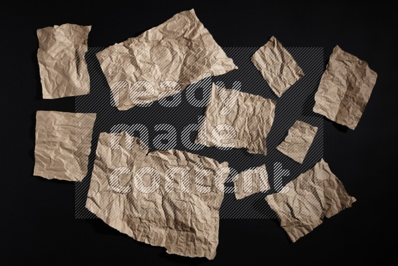 Crumpled craft paper on black background