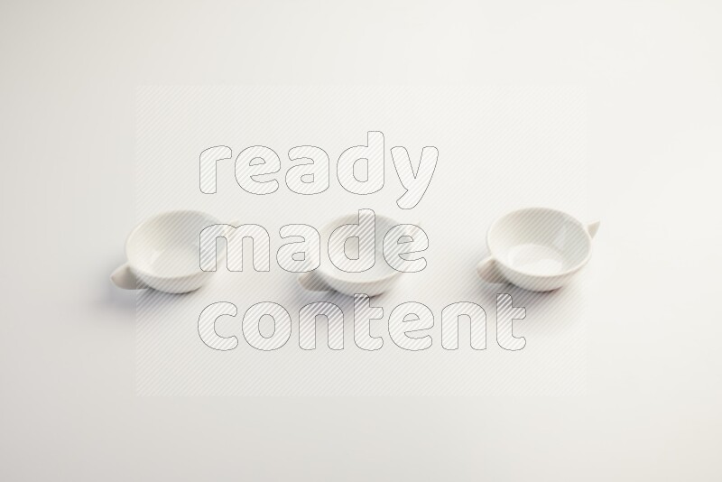 white ceramic round sauce dish on white countertop
