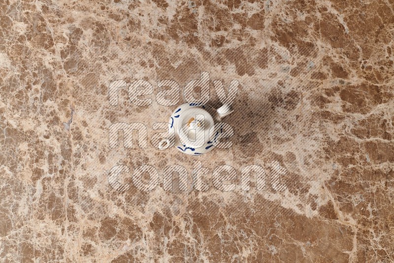 Top View Shot Of A Pottery Teapot On beige Marble Flooring