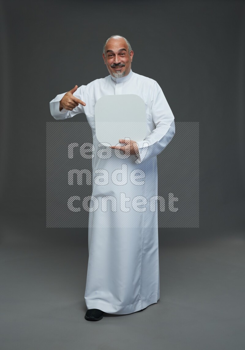 Saudi man without shomag Standing holding social media sing on gray background