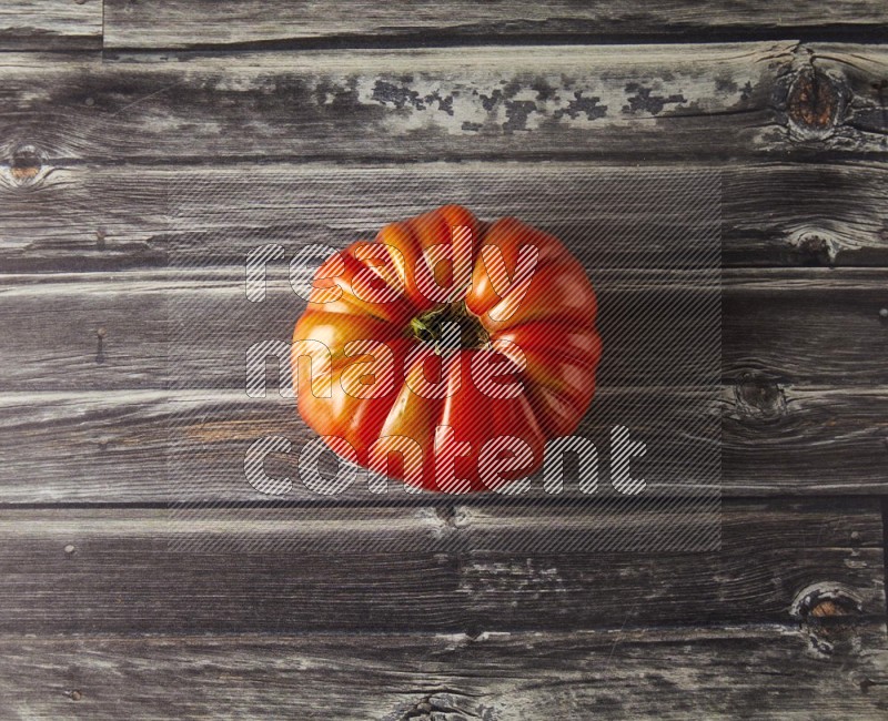Single Tipview Heirloom Tomato on grey wooden background