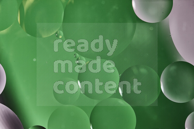 Close-ups of abstract oil bubbles on water surface in shades of white and green