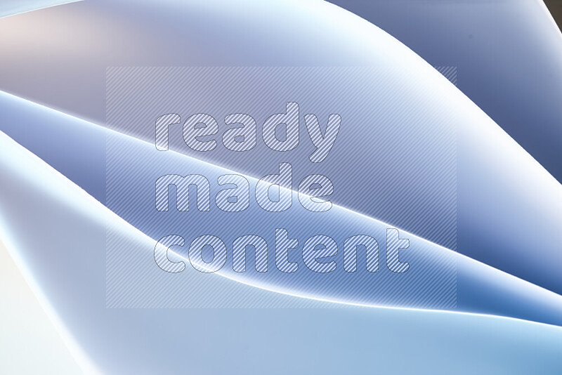 This image showcases an abstract paper art composition with paper curves in blue and white gradients created by colored light