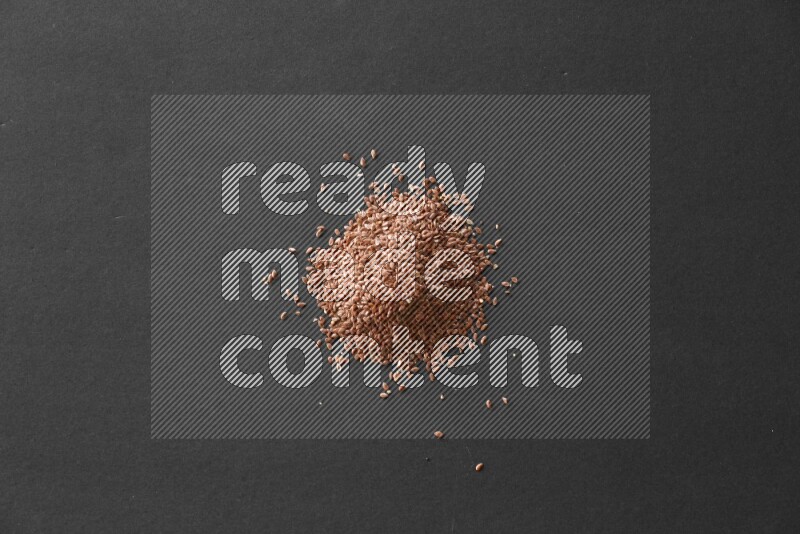 Flax seeds on a black flooring