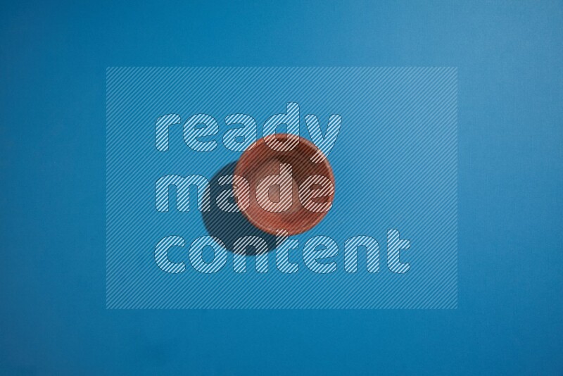 brown bowl on blue background