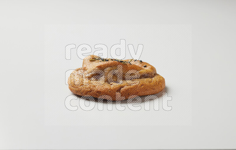 Hasawi cookie field with date and decorated by black seed and Anise grain on a white background