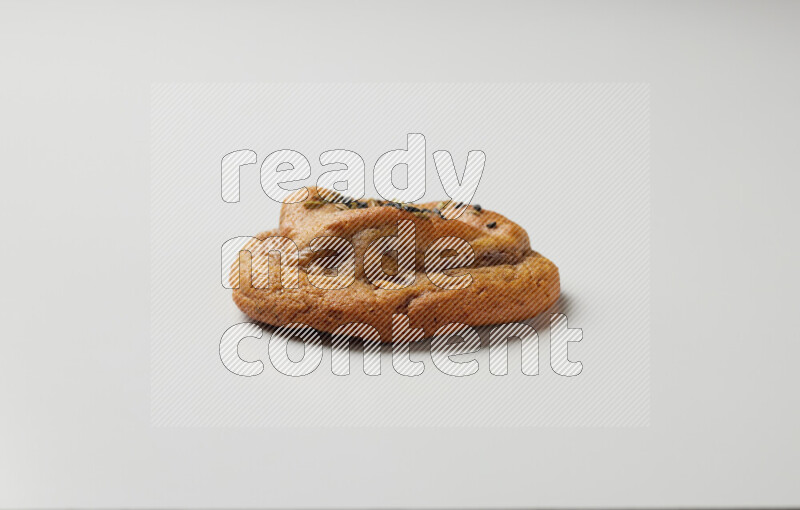 Hasawi cookie field with date and decorated by black seed and Anise grain on a white background