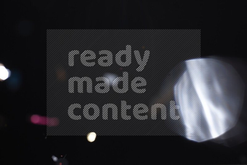 Falling multicolored confetti on black background