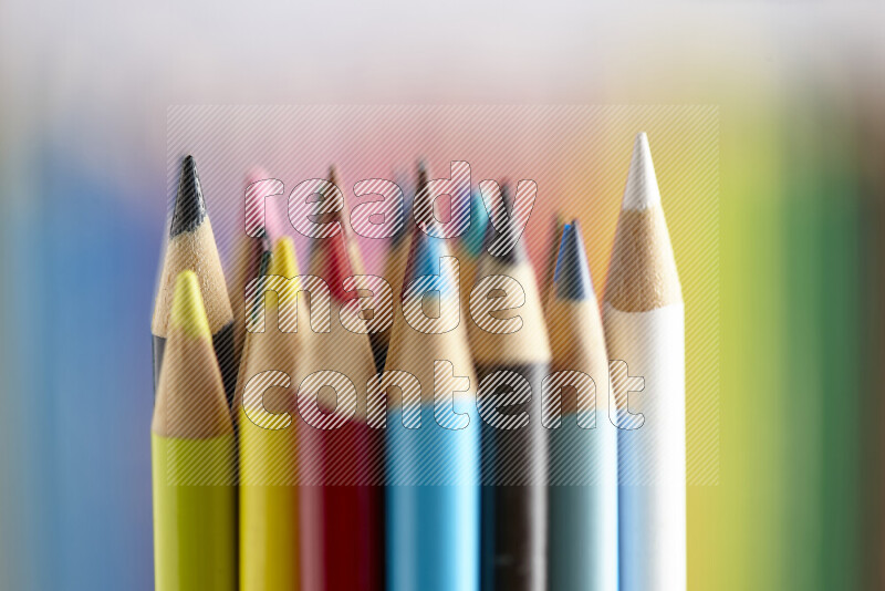 The image captures a close-up of sharpened colored pencils on multicolored background