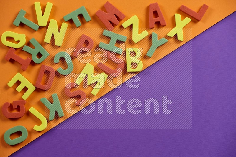 Alphabets letters in foam for kids on orange and purple background (kids toys)